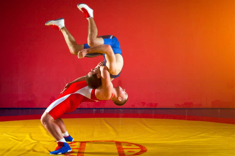 Wrestlers throwing each other after the best protein for wrestlers